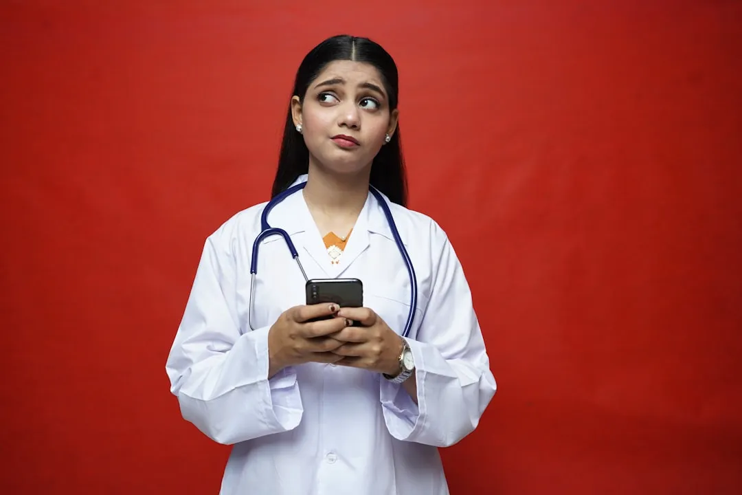 A doctor holding a phone A doctor holding a phone